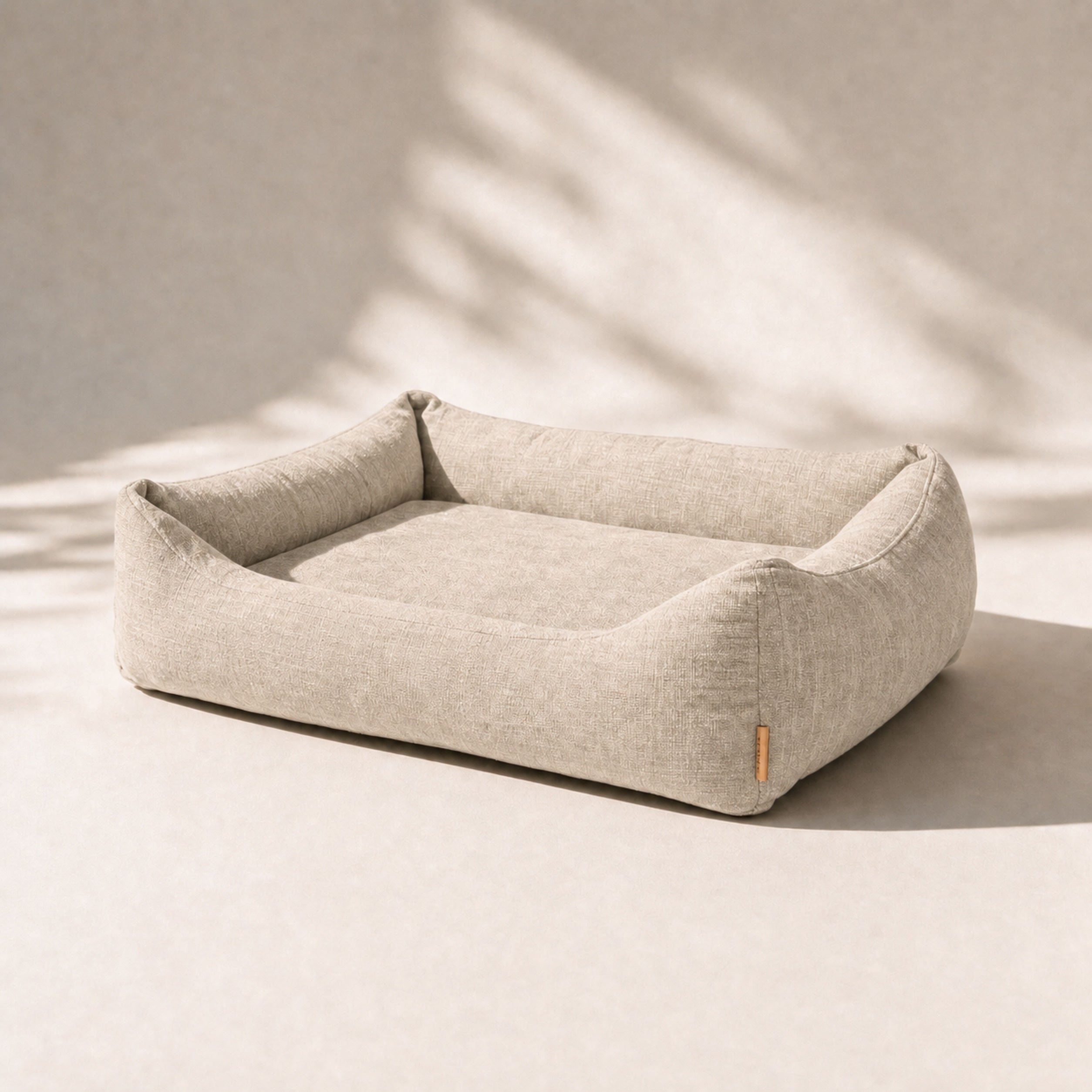 The Lounge dog bed in Bone Linen, front-right studio hero view.