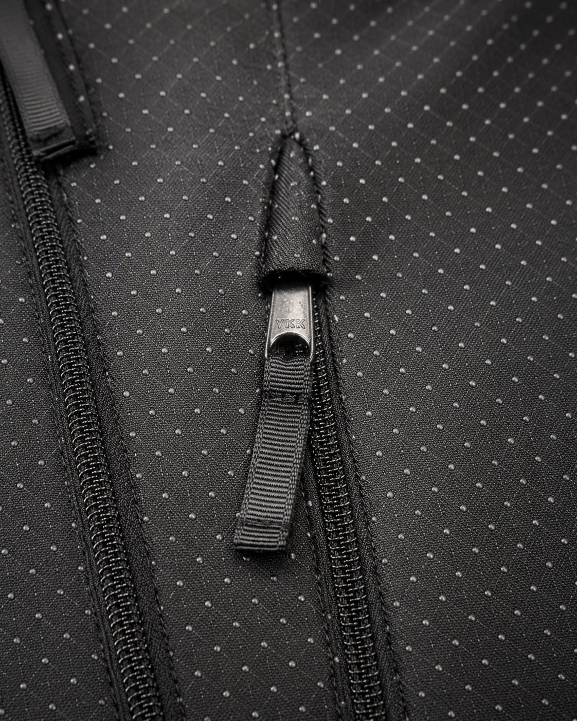 Hidden YKK zipper, pull-tab, and technical backing on The Cover